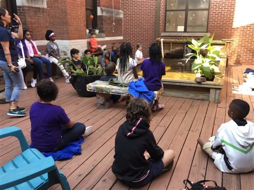 5th graders meditating by pond 