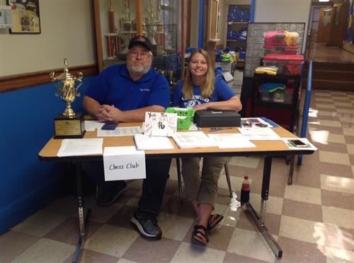 Coack Mark and PTO President Leighann Gipson recruiting Chess Club members at a table 