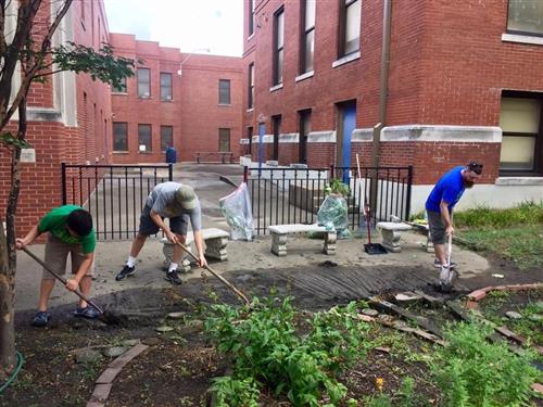Parents, students, and teachers cleaning up the campus 