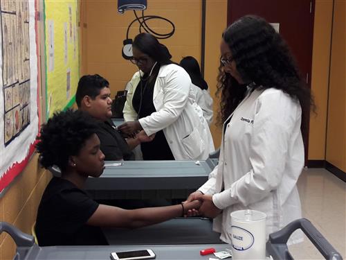 Health Science students performing vital signs skills. 