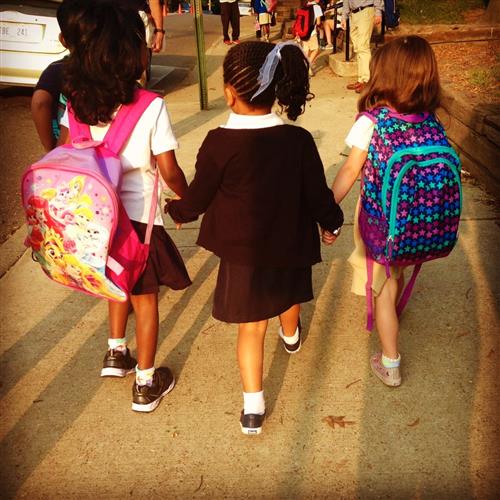 three students walk togetherer 